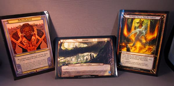 Oversized non-Commander cards from the history of Magic: The Gathering (from left to right: a character card from Vanguard, a plane from Planechase, and a scheme from Archenemy). Image attributed to Wizards of the Coast.