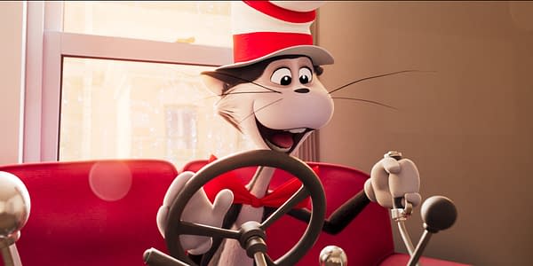A cheerful animated cat wearing a tall red and white striped hat is sitting at the wheel of a car, smiling widely. The car's interior is bright red, with a window showing raindrops in the background.