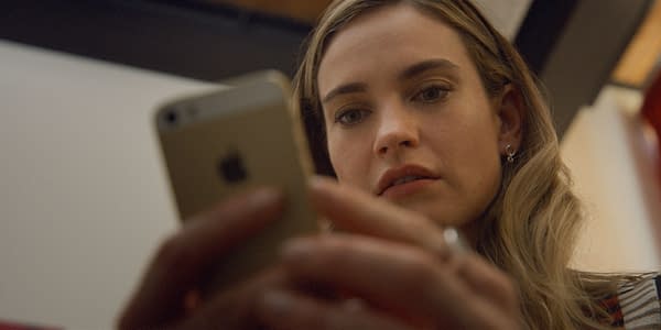 Lily James portrays Whitney Wolfe Herd while focused on her smartphone in a scene from 20th Century Studios' film "Swiped." The image captures her thoughtful expression as she interacts with her device.