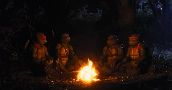 The Teenage Mutant Ninja Turtles sit around a campfire in a dark forest, appearing contemplative and relaxed. Their unique colored bandanas and shells are prominent, creating a nostalgic and adventurous vibe.