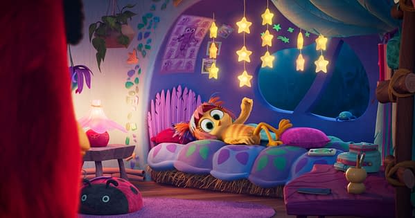 Emma Myers as June lounges on a colorful bed in a cozy, star-lit room from The Angry Birds Movie 3.