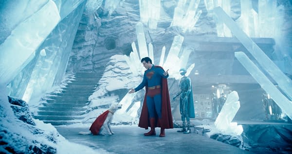 Superman stands in an icy, crystalline environment, interacting with a dog wearing a cape, while a humanoid robot observes nearby. The scene conveys a whimsical mix of superhero and science fiction elements.