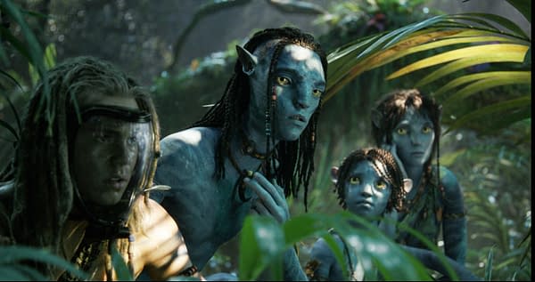 A scene from 'Avatar: Fire and Ash' featuring four characters: Spider, Lo'ak, Tuk, and Kiri. They appear to be observing their surroundings intently in a vibrant, lush jungle setting.
