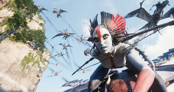 A character named Varang, portrayed by Oona Chaplin, is depicted with dramatic face paint and intricate hair styling while riding a creature. A flock of flying creatures fills the background against a blue sky and rocky landscape.