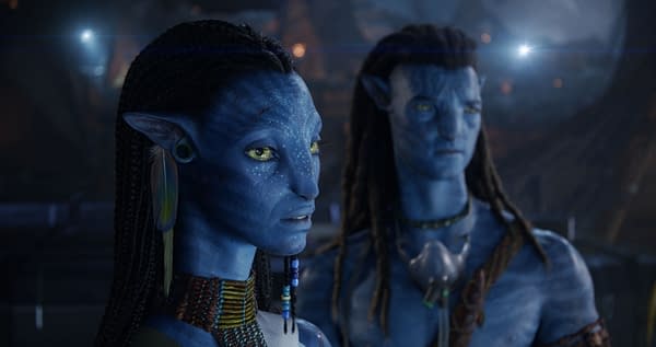 Neytiri and Jake Sully, characters from 20th Century Studios' 'Avatar: Fire and Ash,' are depicted with striking blue skin and unique accessories, showcasing an intense moment. The image highlights their distinctive features and ethereal atmosphere.