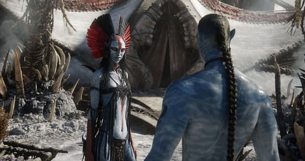 Still from 20th Century Studios' 'Avatar: Fire and Ash' featuring Varang, portrayed by Oona Chaplin, with striking blue skin and ornate accessories, facing another character in a mystical, otherworldly setting.