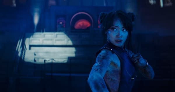 Callina Liang as a fighter in Street Fighter, posed in a blue-lit action scene with fists raised.