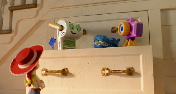 Jessie looks up at Smarty Pants, Atlas, and Snappy peeking out of a drawer in Disney and Pixar's Toy Story 5.