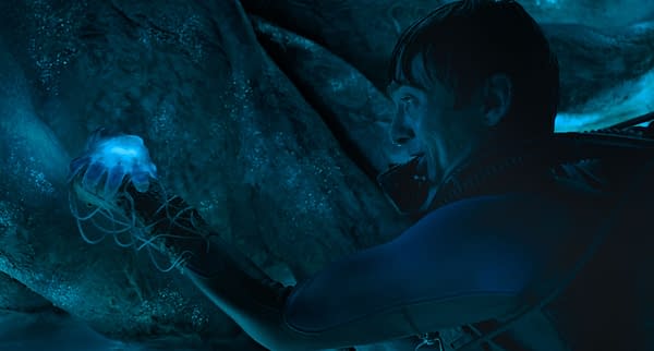 Austin Abrams as Jay Gardiner in Whalefall, floating in a blue-lit underwater scene beside a giant whale's body.