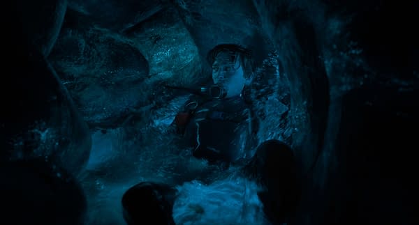 Austin Abrams as Jay Gardiner floats inside the dark blue interior of a whale in Whalefall.