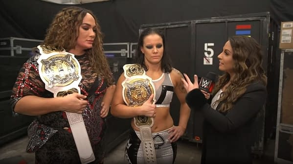Nia Jax and Shayna Baszler celebrate after retaining the WWE Women's Championships against Sasha Banks and Bianca Belair at WrestleMania.