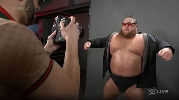 Otis poses for a photo shoot with Maximum Male Models on WWE Raw