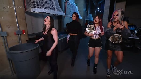 Nikki Cross, with Damage CTRL, throws the WWE 24/7 Championship in the trash