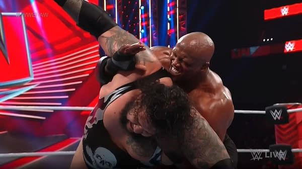 The extra-large Bobby Lashley struggles to wrap his beefy arms around the super-sized shoulders of Bronson Reed on WWE Raw.