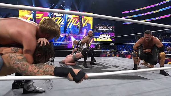 Three wrestlers from The Conglomeration simultaneously apply submission holds on all three members of The Dogs in a wrestling ring during an AEW Revolution event.