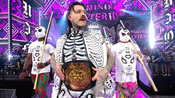 A wrestler, dressed in a skeleton-themed outfit, holds a championship belt while flanked by two masked companions. The vibrant background features colorful lights and designs, enhancing the dramatic atmosphere of the scene.