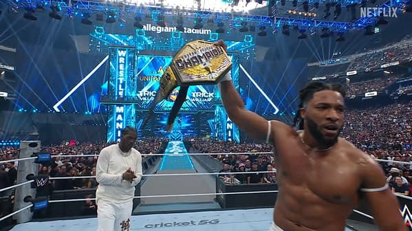 A wrestler, Trick Williams, celebrates with the United States Championship belt raised high in one hand, surrounded by fans and a bright arena at WrestleMania. His impressive physique is visible, and the excitement of the crowd is palpable.