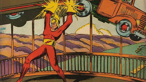 Speed Comics #6 (Brookwood, 1940). A comic book illustration of a muscular superhero in a red outfit lifting a car overhead, surrounded by colorful clouds and a dramatic sky. The action is energy-filled, with visual effects suggesting strength and power.