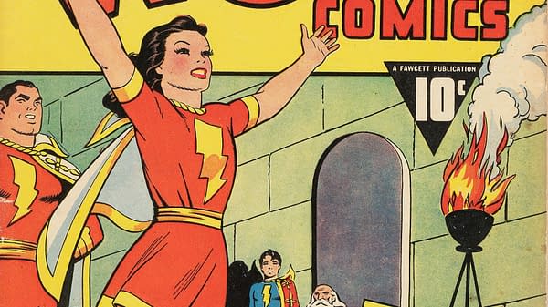 An illustration from Wow Comics #9 featuring Mary Marvel, who is joyfully raising her hands in celebration, wearing a red costume with a lightning bolt emblem. In the background, two other characters are visible, along with a flaming torch.