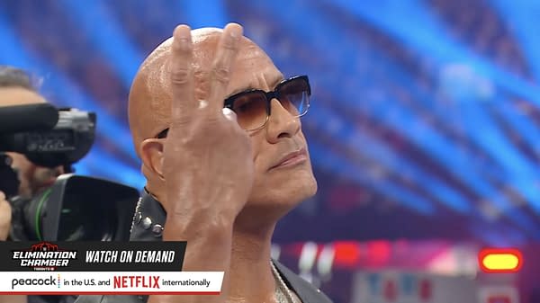 Dwayne "The Rock" Johnson signals John Cena to betray Cody Rhodes with a mysterios two-finger hand gesture.