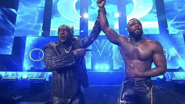 Prince Nana and Swerve Strickland celebrate in the ring after Strickland's victory over Brody King at AEW Revolution, with blue lighting and a bright backdrop enhancing the scene.