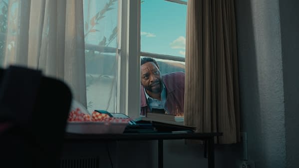 A man peers anxiously through a window into a dim room with curtains, evoking a tense Backrooms scene.