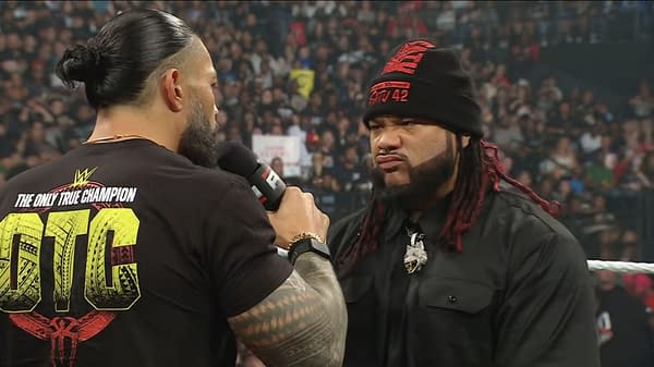 Roman Reigns speaks sternly to Jacob Fatu in the WWE Raw ring during a tense Bloodline confrontation.