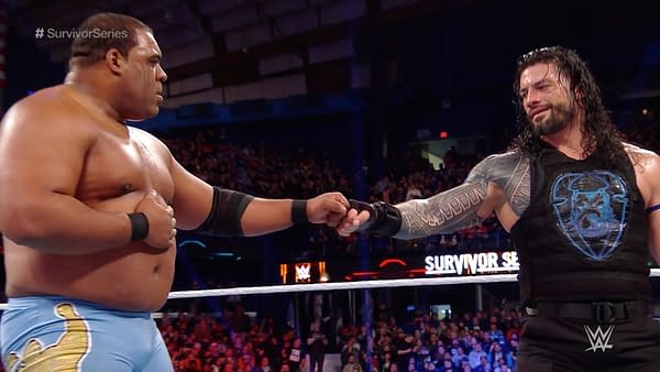 Roman Reigns and Keith Lee bump fists in a mutual show of respect after their WWE Survivor Series confrontation.