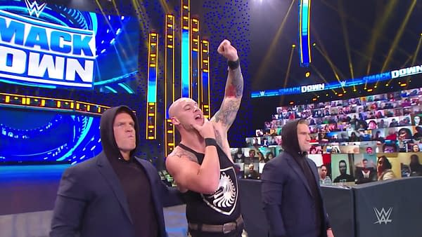 The Ratings King of Friday Nights, Baron Corbin, stands triumphant over The CW's stupid Christmas shows [WWE Smackdown Screencap]