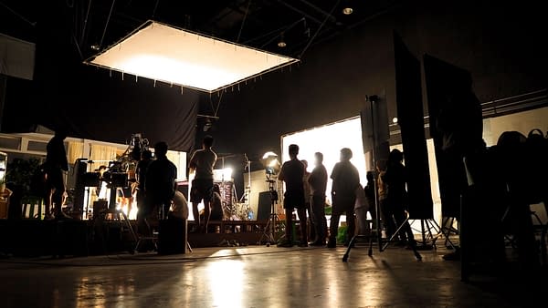 Behind the scenes of video shooting production crew team silhouette and camera equipment in studio. (Image: Shutterstock.com/Royalty-Free)