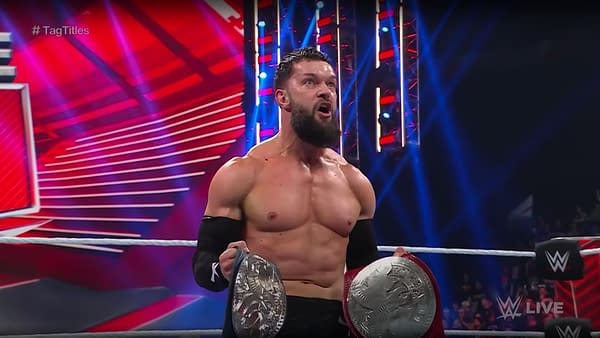 Finn Balor celebrates as Judgment Days wins the tag titles on WWE Raw