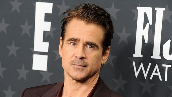 Colin Farrell at the 30th Annual Critics' Choice Awards, wearing a stylish dark suit, with a serious expression in front of a star-patterned backdrop.