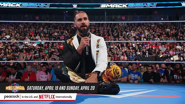 Seth Rollins, wearing a striking black and white outfit adorned with floral patterns, sits on the wrestling ring while delivering a promo during WWE SmackDown on the night before WrestleMania 41, with a large audience in the background.
