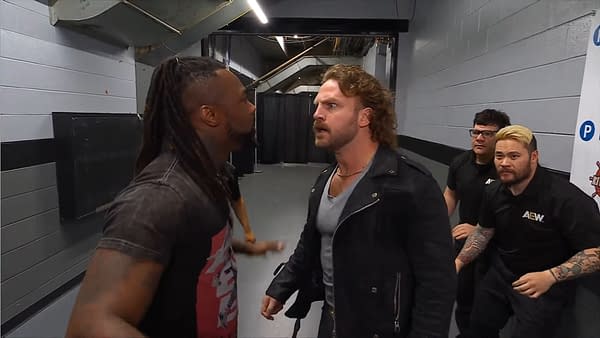 Swerve Strickland and Hangman Page engaged in a fierce verbal confrontation backstage at AEW Dynamite, while other onlookers observe the tension.