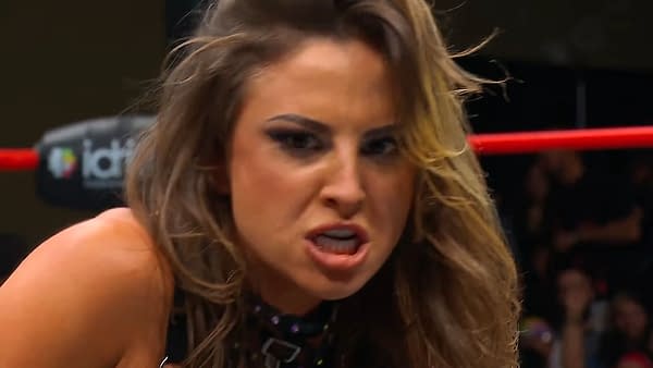 Harley Cameron, a wrestler, shows an intense expression during a match on AEW Collision, with wrestling ropes visible in the background.