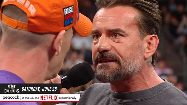 Two men, CM Punk and John Cena, are depicted in a tense face-off during a wrestling promo, with CM Punk speaking passionately into a microphone. The backdrop suggests an event taking place in Saudi Arabia, highlighting their upcoming match.