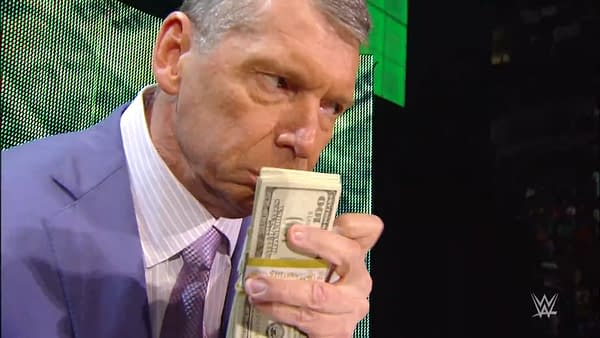 Vince McMahon, dressed in a suit, holds a stack of bills close to his face while expressing enjoyment on WWE Raw in 2008. The background features bright green lighting.