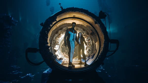 A scene featuring two characters emerging from a futuristic circular pod, set in a deep underwater environment with shimmering lights and structures in the background.