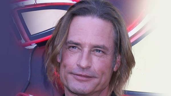 Josh Holloway attends the Duster Series Premiere at Universal Studios in Universal City, CA. The image captures him smiling in front of a colorful backdrop.