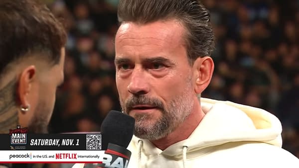 A wrestler, CM Punk, intensely recites a scripted promo on WWE Raw, with an emphasis on a controlled environment that mitigates potential confrontations. The setting is charged as he delivers his lines to another wrestler, shown partially from the side.