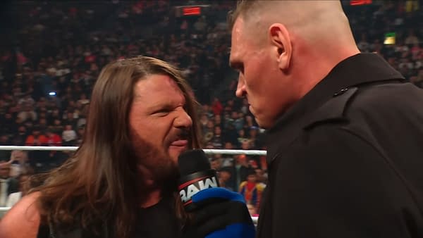 AJ Styles passionately confronts Gunther during a promo on WWE Raw, with an intense crowd visible in the background.