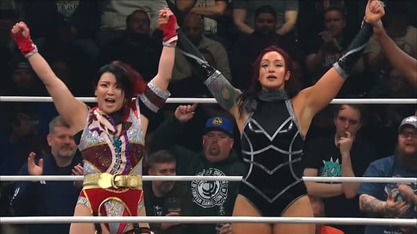 Hikaru Shida and Kris Statlander celebrate their tag team victory at AEW Collision Spring Breakthru, both raising their arms in triumph. The audience is cheering in the background.