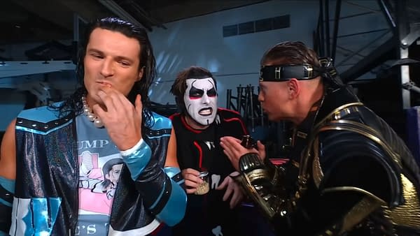 A scene from WWE SmackDown featuring The Miz reprimanding Danhausen, who holds a jar of human teeth, while another wrestler listens intently. The atmosphere is intense with dramatic expressions and colorful costumes.