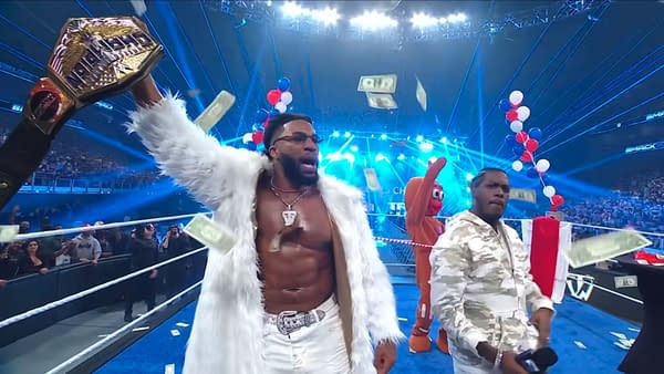 Trick Williams celebrates on WWE SmackDown, holding up a championship belt while money falls around him. Lil Yachty stands nearby as a Gingerbread Man mascot joins the scene.