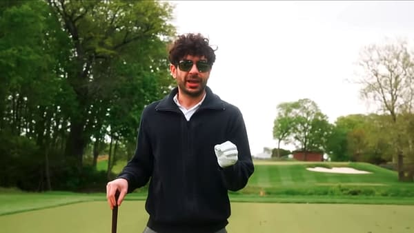 Tony Khan stands on a golf course wearing sunglasses and a white glove, speaking while holding a club. The scene matches AEW Collision: Fairway to Hell.