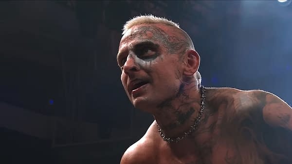 Darby Allin, with face paint and tattoos, looks intensely toward someone off-camera during AEW Dynamite. The close-up suggests he is making a tense proposition.