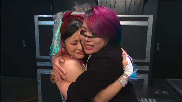 IYO SKY and Asuka share an emotional hug backstage on WWE Raw. Both wrestlers appear teary-eyed as they embrace tightly.