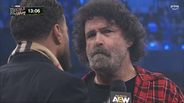 MJF and Mick Foley face off in the ring during the AEW Double or Nothing Buy-In pre-show. Foley wears a red plaid shirt and holds an AEW microphone.