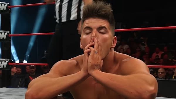 Sammy Guevara pauses in the ring during his AEW Collision match with Darby Allin, hands clasped over his face as he catches his breath.