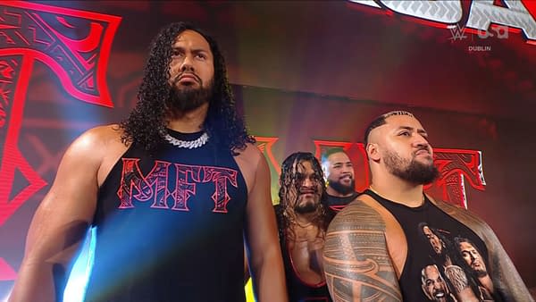 Four WWE SmackDown wrestlers from the MFT group stand onstage under red lighting, facing forward with serious expressions.